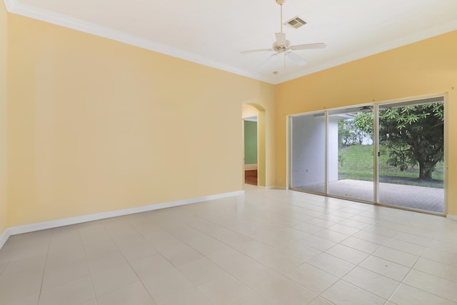 spare room featuring crown molding, ceiling fan, and light tile patterned floors