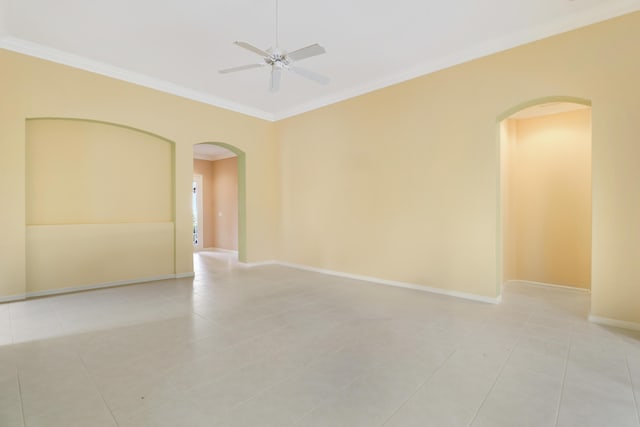 spare room with crown molding, light tile patterned floors, and ceiling fan