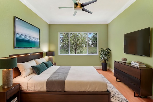 bedroom featuring crown molding, light hardwood / wood-style flooring, and ceiling fan