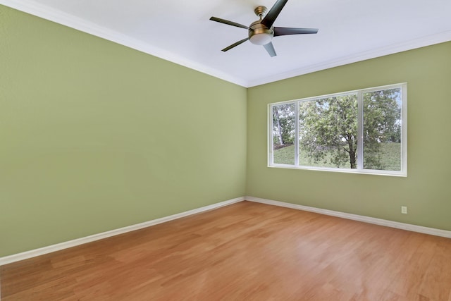 unfurnished room with ornamental molding, plenty of natural light, ceiling fan, and light hardwood / wood-style floors