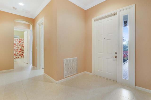 entrance foyer featuring light tile patterned floors and crown molding