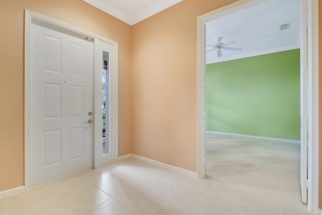 tiled entryway with crown molding and ceiling fan