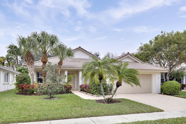 view of front of home with a garage and a front lawn