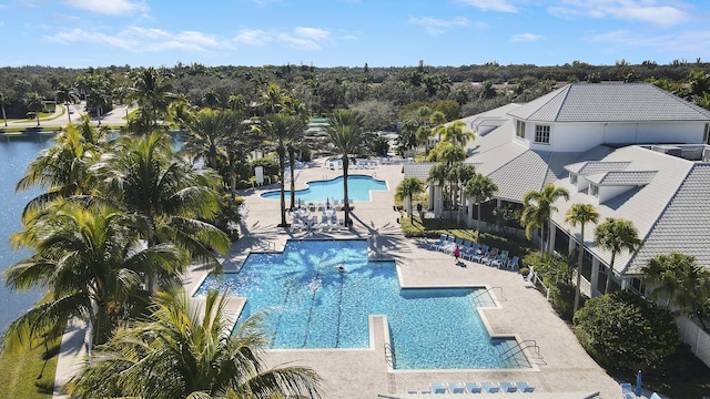 view of swimming pool with a water view and a patio area