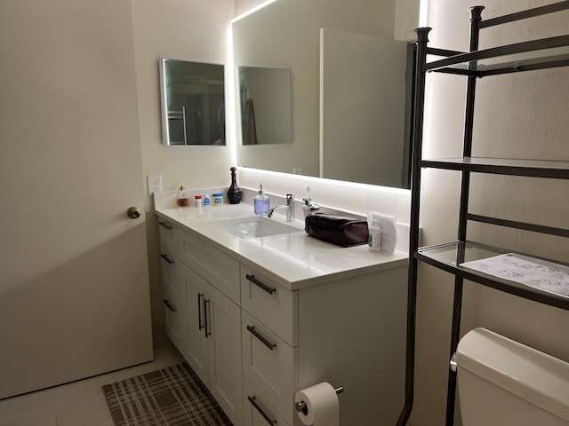 bathroom with tile patterned floors, vanity, and toilet