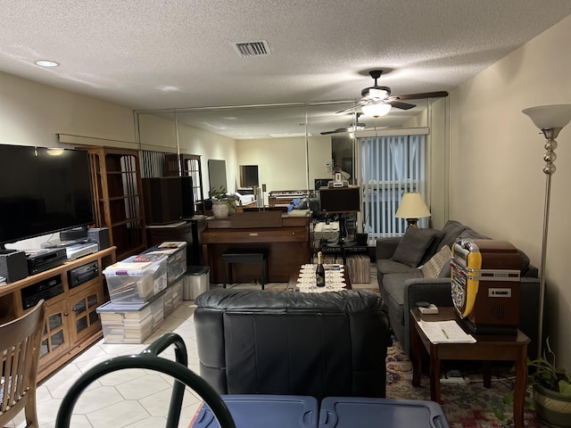 living room featuring a textured ceiling and ceiling fan