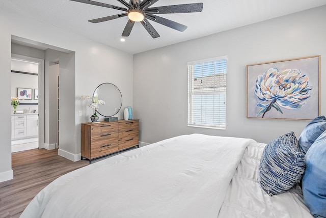 bedroom with hardwood / wood-style flooring, ceiling fan, and ensuite bathroom