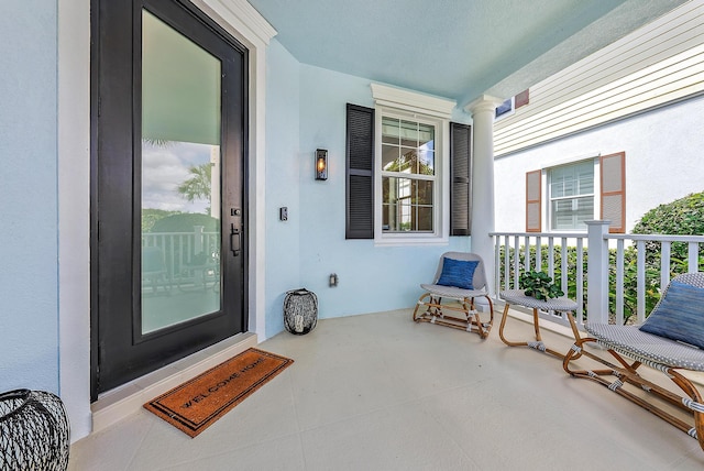 view of exterior entry with covered porch