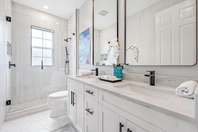 bathroom featuring tile patterned flooring, vanity, walk in shower, and toilet