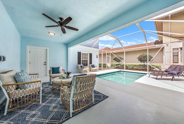 view of pool featuring ceiling fan, a lanai, and a patio area