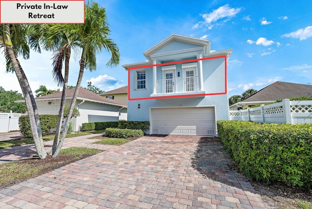 view of front of house with a garage and a balcony