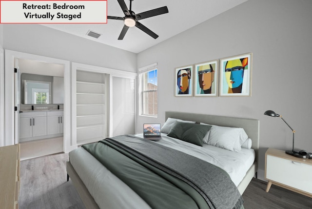 bedroom with ceiling fan, ensuite bath, and light wood-type flooring