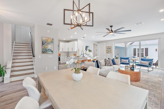 dining room with ceiling fan and light wood-type flooring