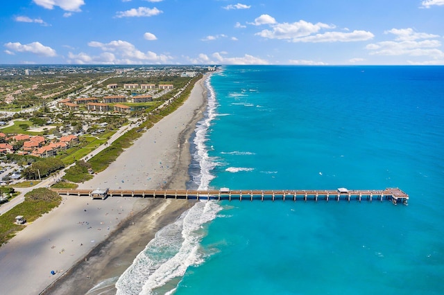 bird's eye view featuring a water view and a beach view