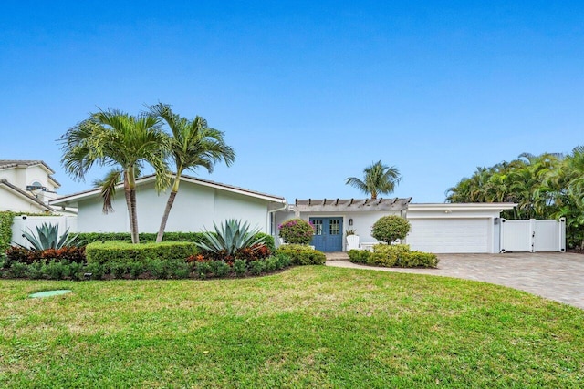 ranch-style house featuring a garage and a front yard