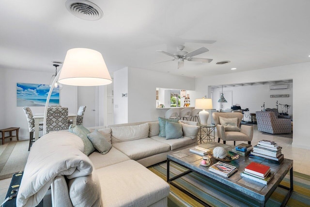 living room featuring a ceiling fan and visible vents