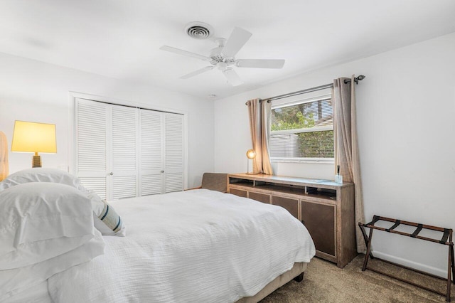 carpeted bedroom featuring a closet, visible vents, and ceiling fan