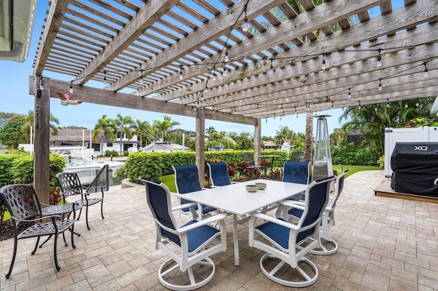 view of patio with a grill, a pergola, and outdoor dining space