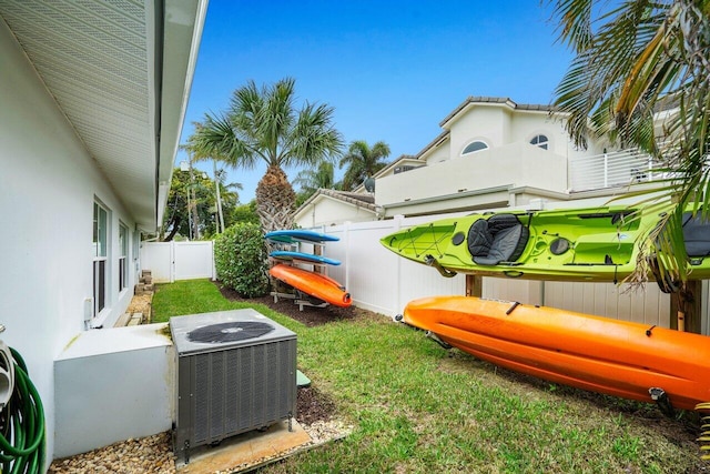 view of yard featuring central AC and a fenced backyard