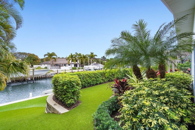 view of home's community featuring a water view and a yard