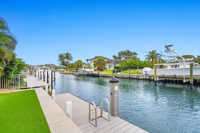 view of dock featuring a water view and a lawn