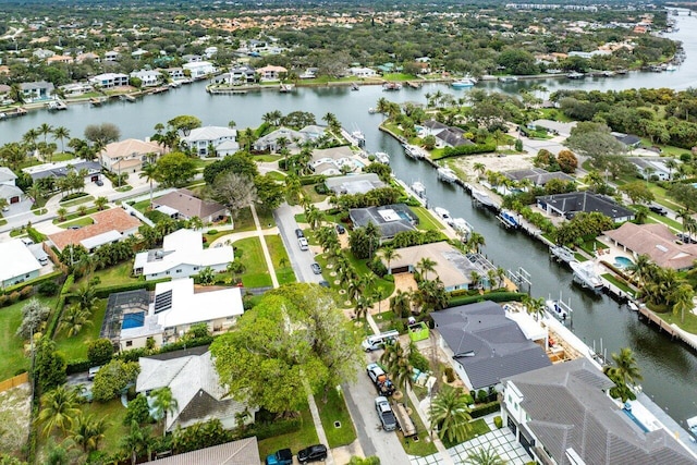 drone / aerial view with a water view and a residential view