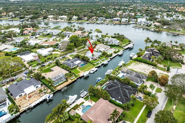 birds eye view of property featuring a water view and a residential view