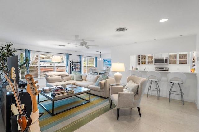 living area featuring recessed lighting, visible vents, baseboards, ceiling fan, and light tile patterned flooring