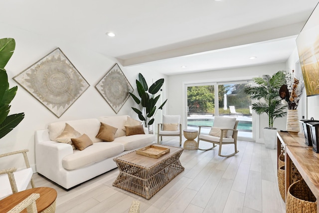 living room with light hardwood / wood-style flooring and beam ceiling