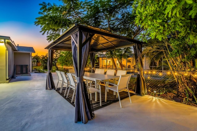 patio terrace at dusk featuring a gazebo