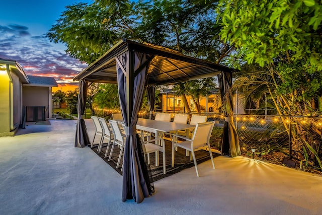 patio terrace at dusk featuring a gazebo