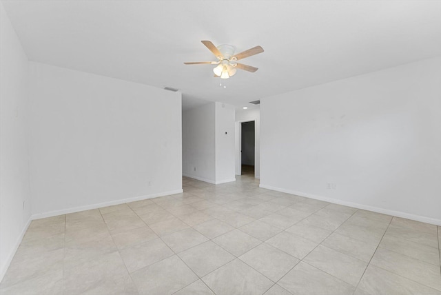 empty room featuring light tile patterned floors and ceiling fan