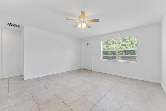 empty room featuring light tile patterned flooring and ceiling fan