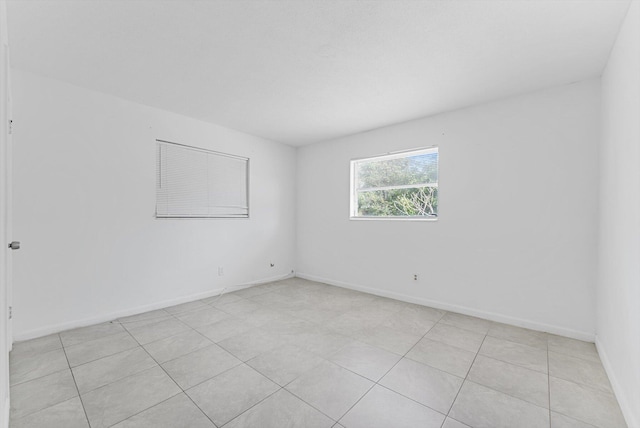 spare room featuring light tile patterned floors