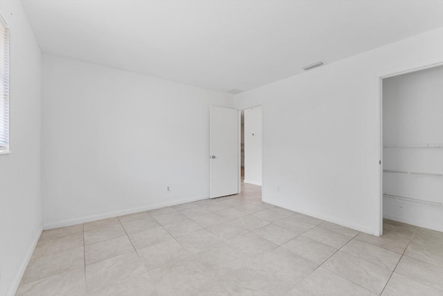 unfurnished bedroom featuring a closet and light tile patterned floors