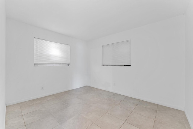 unfurnished room featuring light tile patterned floors