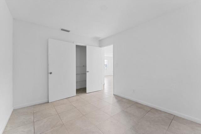 empty room with light tile patterned floors