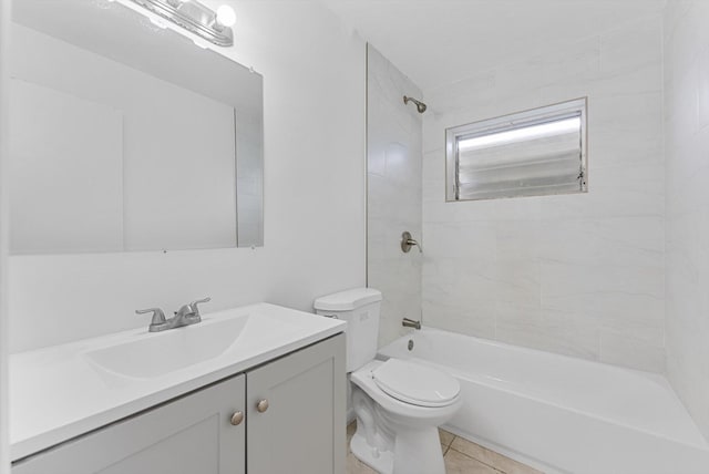 full bathroom with tile patterned floors, toilet, vanity, and tiled shower / bath combo