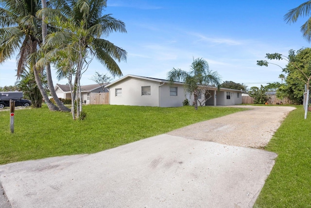 ranch-style house featuring a front yard