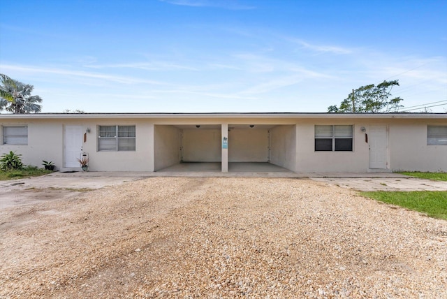 view of front of property featuring a carport