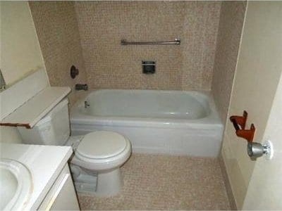 4 Northampton A 4, West Palm Beach, FL 33417 - bathroom with toilet, vanity, tile patterned flooring, and shower / bath combination