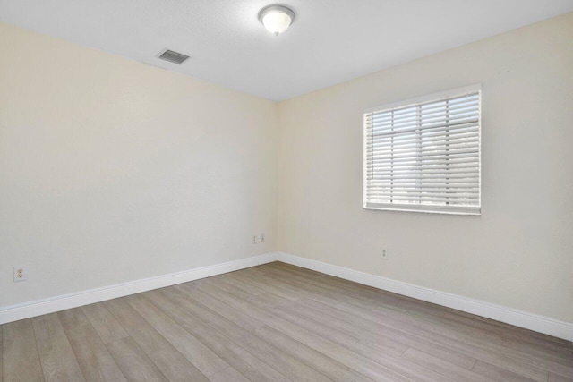 spare room featuring light hardwood / wood-style flooring