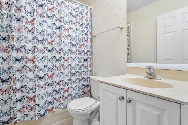 bathroom with vanity, toilet, and curtained shower