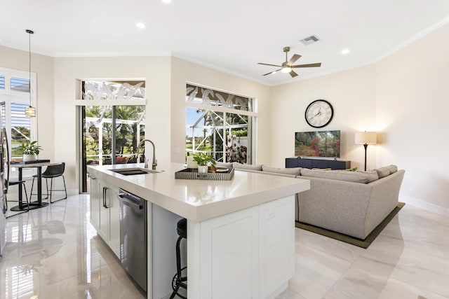 kitchen featuring a kitchen island with sink, hanging light fixtures, stainless steel dishwasher, and white cabinets