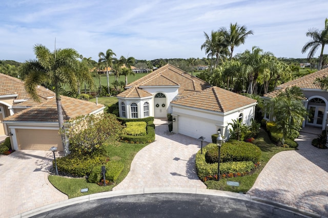 mediterranean / spanish home featuring a garage