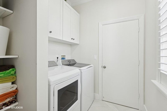 washroom featuring washer and clothes dryer and cabinets