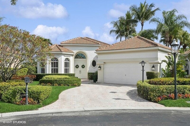 mediterranean / spanish house with a garage