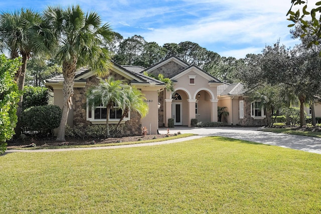 mediterranean / spanish home featuring a front yard