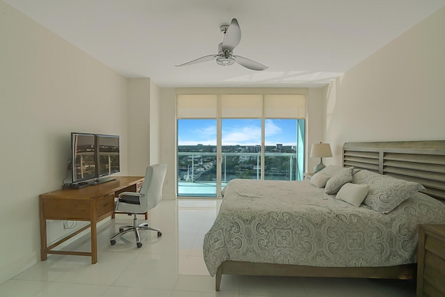 tiled bedroom with expansive windows and ceiling fan