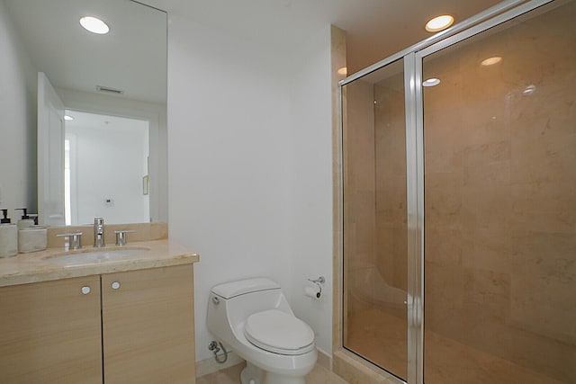 bathroom with walk in shower, vanity, and toilet